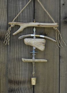 a wind chime hanging on the side of a wooden fence