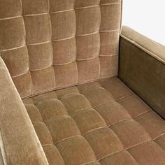 a brown couch with an arm rest on it's back and the seat upholstered