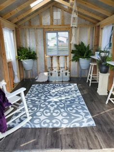 a porch with rocking chairs and potted plants