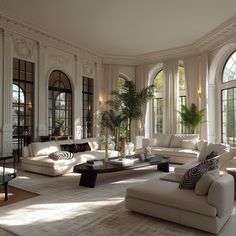 a large living room with white couches and windows