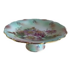 This Bavaria Cake Stand / serving plate is a beauty!  It is a hand painted porcelain pedestal cake plate with painted pastel flowers by Schumann Arzberg Bavaria Germany.  It's stamped with the lion in the shield which dates this back to the 1920s.  It has pink flowers with a green & white background and a gold scalloped border.  Your favorite cake will look exquisite in this cake stand.  It is in excellent vintage condition.  Some wear is expected with age and use. Green White Background, Cake Stand Pedestal, Pedestal Cake Plate, Cake Plates Stand, Scalloped Border, Pedestal Cake Stand, 1920s Vintage, Plate Stands, Bavaria Germany