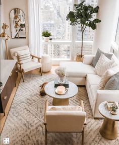 a living room filled with furniture and a large window over the top of a white couch