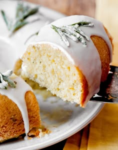 a white plate topped with a cake covered in frosting