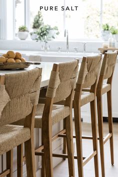 there are many chairs around the table in this kitchen