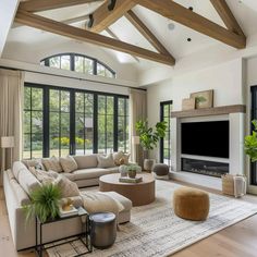 a living room filled with lots of furniture and a flat screen tv mounted on the wall