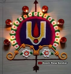 a decorated rangolim with candles and flowers on the wall for diwaling