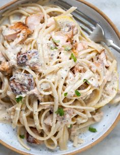 a white plate topped with pasta and meat