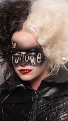 a woman with white hair and black makeup has the words future painted on her face