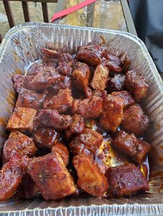 a pan filled with meat sitting on top of a table