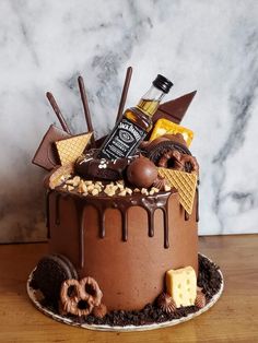 a large chocolate cake covered in lots of different types of desserts and toppings