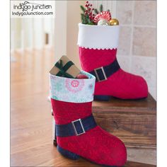 two red and white christmas boots with presents in them