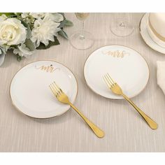 two white and gold plates with the names mr and mrs written on them next to each other