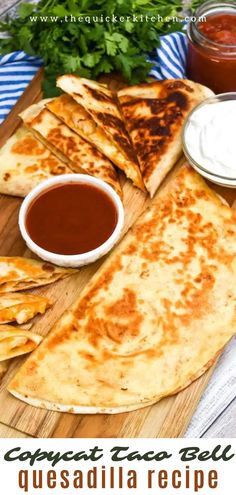 quesadilla on a cutting board with dipping sauce