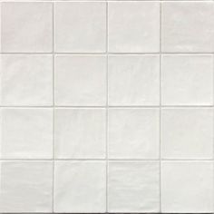 a white tile wall with square tiles on it