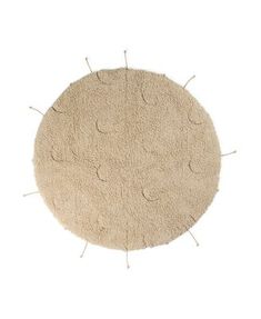 a round rug with pins sticking out of the center on a white background, top view