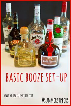 bottles of liquor sitting on top of a table with the words basic booze set - up