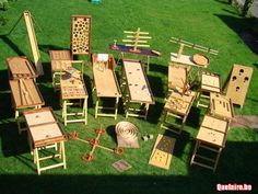 several wooden tables and chairs sitting in the grass