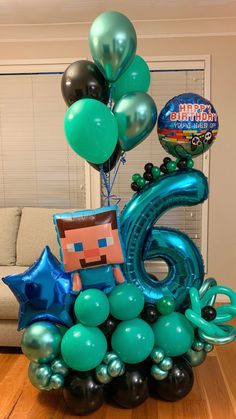 a bunch of balloons that are in the shape of an 6th birthday cake and number six