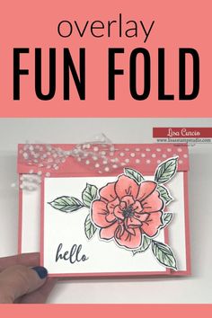 a hand holding up a card with the words overlay fun fold written on it