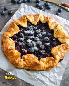 a blueberry pie with powdered sugar on top