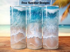 three glass vases with water and sand in them on a wooden table next to the ocean