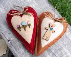 two heart shaped ornaments are sitting on a bench