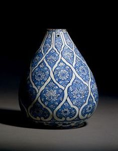 a blue and white vase sitting on top of a table