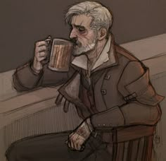 a man sitting in a chair drinking from a cup with his hand on the table