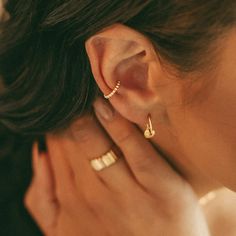 Make a statement with this dainty Cam Ear Cuff. No piercing necessary, just slide the ear cuff on your ear for effortless party-ready style. Look chic minus the commitment. Created with a sterling silver base and utilizing an extra luxurious 18 karat gold plating for the perfect finish. Gold Plate 10mm Outer Diameter Nickel- & Lead-Free Cuff Piercing Ear, Golden Ear Cuff, Eat Cuffs, Ear Piercing Designs, Gold Earring Cuff, Conch Cuff, Earring Stacks, Ear Cuff Gold, Ear Cuff Piercing