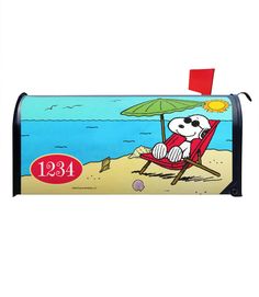 a mailbox with a cartoon dog sitting in a beach chair