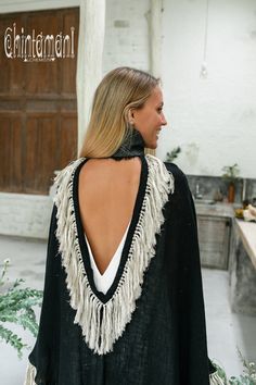 Cotton Open Back Poncho is a very original designer garment to compliment your boho outfit on a cool summer evening. High cotton canvas collar is reminiscent of elegant XIX century lady cloak, while long gorgeous linen fringe on the hemline brings an ultimate boho touch to the piece. The back of the poncho is open and also decorated with the statement fringes of our Alma Libra collection. It is made of 100% natural raw and very soft cotton. In hot climate you can wear this Poncho with our open b Bohemian Long Sleeve Cape One Size, Bohemian Long Sleeve Cape For Festivals, Bohemian Cape With Tassels For Fall, Bohemian Tassel Cape For Fall, Bohemian Poncho For Festivals, One Size Bohemian Cape For Festivals, Traditional Black Cape For Festival, Black Cape For Fall Festivals, Black Fall Festival Cape