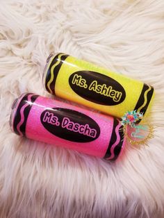 two pink and yellow lip bales sitting on top of a white fur covered floor