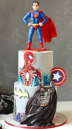 a birthday cake with a superman figure on top