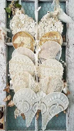 an old window is decorated with lace and flowers