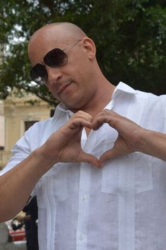 a man making a heart with his hands