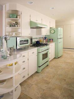 a kitchen with green appliances and white cabinets