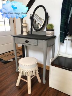 a small table with a mirror and stool