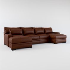 a brown leather sectional sofa sitting on top of a white floor