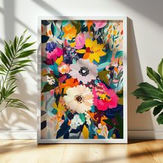 an art print on a wall next to a potted plant