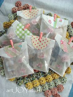 several small bags filled with lots of different things on top of a blue and white table cloth