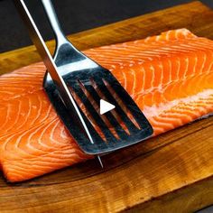 a piece of salmon being cut with a fork