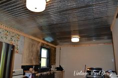 an unfinished kitchen with a metal ceiling and stove