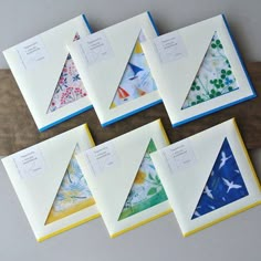 six folded cards with different designs on them