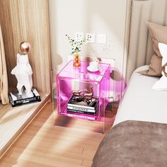 a bed room with a neatly made bed and a pink side table next to it