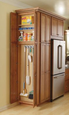 an organized pantry in the middle of a kitchen with cleaning supplies and other household items