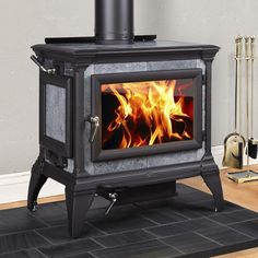 a stove that is sitting in the middle of a room with a rug on it