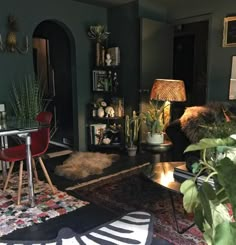 a living room filled with furniture and plants