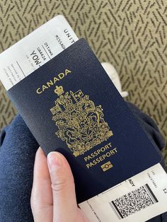 a person holding a canadian passport in their hand