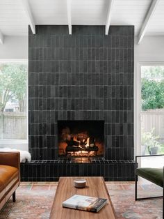 a living room filled with furniture and a fire place in the middle of a fireplace