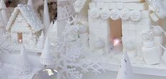 there are many white gingerbread houses on display